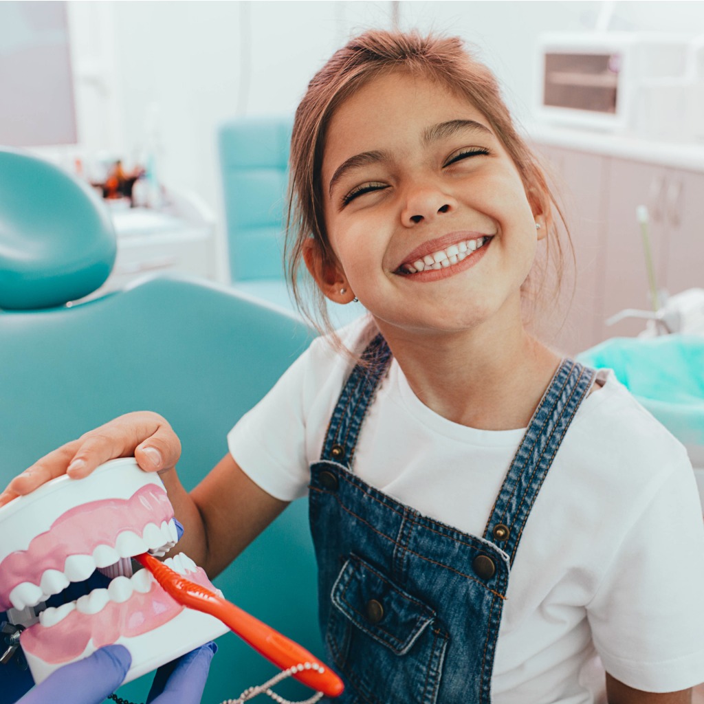 mixed race girl perfect toothy smiling at camera while sitting in picture id1165526777